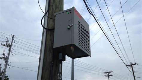 steel box on pole on side of road|alpha box on pole.